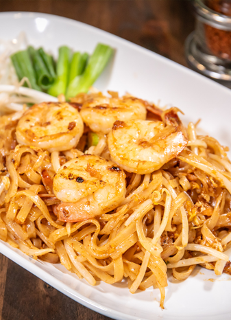 Delicious Thai cuisine served at The Baht Gatlinburg – vibrant dishes with authentic flavors and a modern presentation by the river.